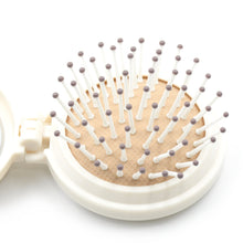 Portable hair brush with mirror, folds for easy packing and travel