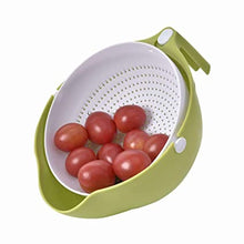 Washing bowl with strainer and handle for efficient fruit and vegetable cleaning.