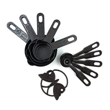 Black plastic measuring cups and spoons set with an 11-piece collection, including a butterfly-shaped holder